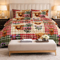 A made bed in a styled bedroom setting featuring a plaid and animal print bedding set with Highland cows, thistles, and stags. The bedding has a patchwork design with red, green, beige, and brown tones.